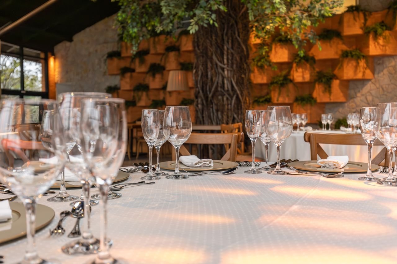 Elegant table setting in a restaurant with wine glasses and stylish decor.